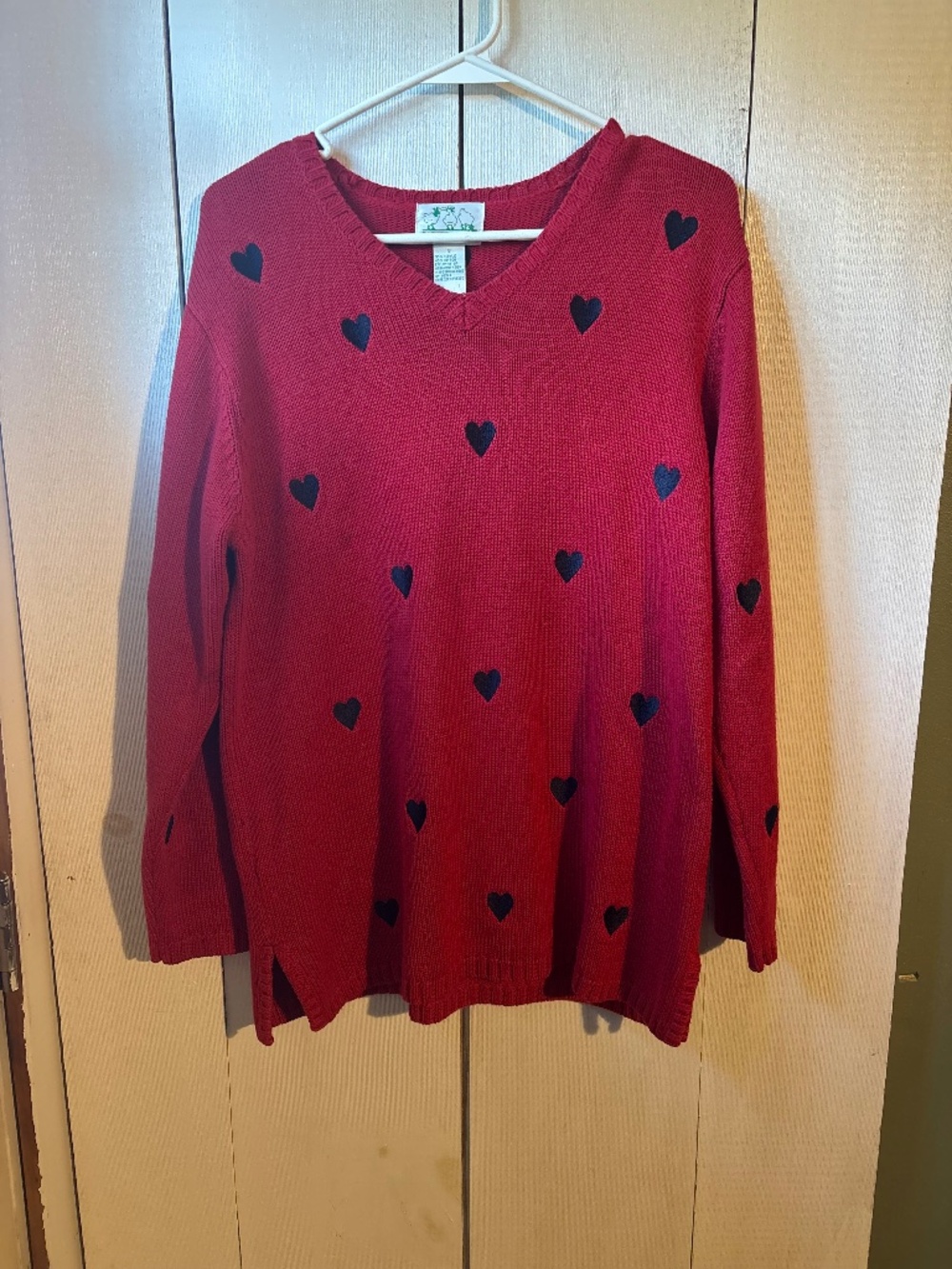 Woman’s red heart sweater
